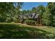 Traditional brick home showcasing a well-manicured lawn with mature trees at 118 Tayport Dr, Troutman, NC 28166