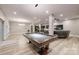 Spacious game room with a pool table, neutral colors, and hardwood floors at 118 Tayport Dr, Troutman, NC 28166