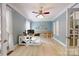 Bright home office with custom wood shelving and a modern desk setup at 118 Tayport Dr, Troutman, NC 28166