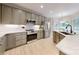 Modern kitchen with stainless steel appliances, light countertops, and light wooden floors at 118 Tayport Dr, Troutman, NC 28166