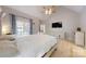 Relaxing main bedroom showcasing light wood floors, en suite bath and large window with curtains at 118 Tayport Dr, Troutman, NC 28166