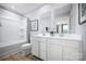 Bright bathroom featuring a double vanity, framed mirrors, and a shower over tub with neutral colors at 12013 Beaux Art Ln, Charlotte, NC 28214