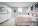 Cozy bedroom features a bright window, neutral walls, and white furniture for storage at 12013 Beaux Art Ln, Charlotte, NC 28214