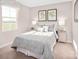 Peaceful bedroom with soft lighting, and a picturesque view from the large window at 12013 Beaux Art Ln, Charlotte, NC 28214