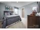 Well-lit bedroom with neutral carpeting, a bright window, and themed wall decor at 12013 Beaux Art Ln, Charlotte, NC 28214