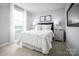 Serene bedroom with large window, soft lighting, neutral colors, and stylish decor creating a relaxing space at 12013 Beaux Art Ln, Charlotte, NC 28214