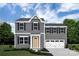 Two-story home featuring gray siding, a yellow front door, and a well-manicured lawn at 12013 Beaux Art Ln, Charlotte, NC 28214