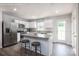 Modern kitchen with white cabinets, stainless steel appliances, a kitchen island and wood-look flooring at 12013 Beaux Art Ln, Charlotte, NC 28214