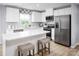 Bright kitchen featuring white cabinets, stainless steel appliances, and a large island with seating at 12013 Beaux Art Ln, Charlotte, NC 28214