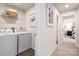 Convenient laundry room with washer, dryer, shelf, and wall art at 12013 Beaux Art Ln, Charlotte, NC 28214