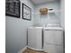 Functional laundry area with modern appliances, storage shelves, and tasteful decor for added convenience and style at 12013 Beaux Art Ln, Charlotte, NC 28214