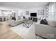 Spacious living room with comfortable seating, modern decor, and plenty of natural light at 12013 Beaux Art Ln, Charlotte, NC 28214