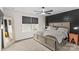 Bedroom with a king-size bed, ceiling fan, and a large window overlooking the backyard at 124 Kristin View Ln # C, Troutman, NC 28166