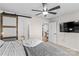 This bedroom includes a ceiling fan, TV, and barn door to bathroom at 124 Kristin View Ln # C, Troutman, NC 28166