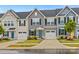 Charming townhome exterior featuring a well-manicured lawn, attached garage, and classic architectural details at 124 Kristin View Ln # C, Troutman, NC 28166