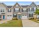 Charming townhome exterior featuring a well-manicured lawn, attached garage, and classic architectural details at 124 Kristin View Ln # C, Troutman, NC 28166