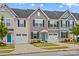 Charming townhome exterior featuring a well-manicured lawn, attached garage, and classic architectural details at 124 Kristin View Ln # C, Troutman, NC 28166