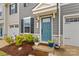 Charming entryway with a bright front door, manicured landscaping, and stone accents at 124 Kristin View Ln # C, Troutman, NC 28166