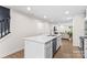 Bright, open concept kitchen with a large island, stainless steel appliances, and hardwood floors at 124 Kristin View Ln # C, Troutman, NC 28166