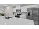 Modern kitchen features stainless steel appliances and a large center island with white countertops at 124 Kristin View Ln # C, Troutman, NC 28166