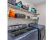 Modern laundry room with a washer, dryer, and shelving for storing laundry supplies at 124 Kristin View Ln # C, Troutman, NC 28166