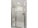Bathroom shower with tiled walls, glass door, and built-in bench at 124 Kristin View Ln # C, Troutman, NC 28166