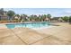 Community swimming pool surrounded by lounge chairs, tables, and chairs with lush landscaping in background at 124 Kristin View Ln # C, Troutman, NC 28166