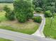 Aerial view of property featuring a long driveway, mature trees, and a well-maintained lawn at 13101 Pine Bluff Rd, Midland, NC 28107
