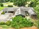 Aerial view of home featuring large carport, skylights and mature trees at 13101 Pine Bluff Rd, Midland, NC 28107