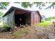 View of open barn structure with brick wall and storage area in a rural setting at 13101 Pine Bluff Rd, Midland, NC 28107