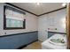 Vintage bathroom with patterned wallpaper, a dual sink vanity, and a small window at 13101 Pine Bluff Rd, Midland, NC 28107