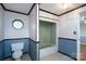 Bathroom including a toilet, blue tub and shower, and octagon-shaped window at 13101 Pine Bluff Rd, Midland, NC 28107