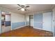 Bedroom featuring wallpapered walls, wood floors, and mirrored closet doors at 13101 Pine Bluff Rd, Midland, NC 28107