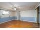 This bedroom features wallpapered walls, wood floors, and an overhead light at 13101 Pine Bluff Rd, Midland, NC 28107
