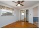 Bedroom with hardwood flooring, an overhead light, mirrored closet doors, and window at 13101 Pine Bluff Rd, Midland, NC 28107