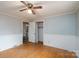 Bedroom featuring light colored walls, wood floors, a ceiling fan, and closet at 13101 Pine Bluff Rd, Midland, NC 28107