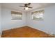 This bedroom has hardwood floors, an overhead light, and two windows at 13101 Pine Bluff Rd, Midland, NC 28107
