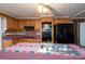 Kitchen with wood cabinets, black appliances, and an island with a stainless steel sink at 13101 Pine Bluff Rd, Midland, NC 28107