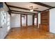 Spacious living room with exposed beams, hardwood floors, and two doorways to other rooms at 13101 Pine Bluff Rd, Midland, NC 28107