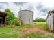 Picture of a rusted silo between two outbuildings, surrounded by green space at 13101 Pine Bluff Rd, Midland, NC 28107