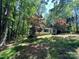 Single-story home nestled in a wooded setting, offering privacy and natural beauty at 1399 Branton Dr, Iron Station, NC 28080