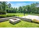 Enjoy this home's spacious backyard with a fire pit and a basketball hoop at 14105 Ryker Way, Davidson, NC 28036