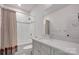 Well-lit bathroom features a bathtub and shower combination with white tile surround and a modern vanity with a quartz countertop at 14105 Ryker Way, Davidson, NC 28036