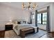 Neutral Primary bedroom with dark trim windows, wood floors, and a patterned rug at 14105 Ryker Way, Davidson, NC 28036