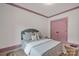 Calm bedroom with pink accents, a plush bed, natural rug, and soft lighting for a relaxing atmosphere at 14105 Ryker Way, Davidson, NC 28036