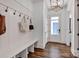 Inviting entryway with bench seating, coat hooks, wood flooring, and modern lighting at 14105 Ryker Way, Davidson, NC 28036