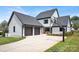 A sprawling home exterior with an attached 3-car garage, basketball court, and outdoor dining at 14105 Ryker Way, Davidson, NC 28036