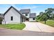 A sprawling home exterior with an attached 3-car garage, basketball court, and well-manicured lawn at 14105 Ryker Way, Davidson, NC 28036