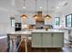 This kitchen features an island with stone countertops and stainless steel appliances at 14105 Ryker Way, Davidson, NC 28036