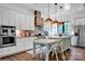 Spacious kitchen with white cabinets, a center island, stainless steel appliances, and wood flooring at 14105 Ryker Way, Davidson, NC 28036